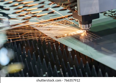 The Fiber  Laser Cutting Machine  Cutting The Sheet Metal Plate With The Sparking Light.Hi-technology Manufacturing Concept.