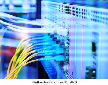 Fiber Optic cables connected to an optic ports - Shutterstock ID 648655840