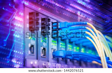 Fiber Optic cables connected to optic ports and UTP, Network cables connected to ethernet ports.