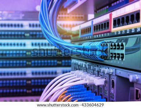 Fiber Optic cables connected to an optic ports and UTP Network cables connected to ethernet ports.