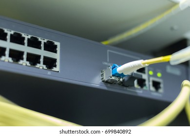 Fiber optic connecting on core network swtich - Shutterstock ID 699840892