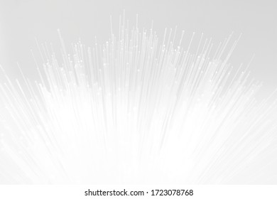 Fiber optic light strands in soft white abstract background with glowing points and minimal design for technology, communication, and futuristic concept