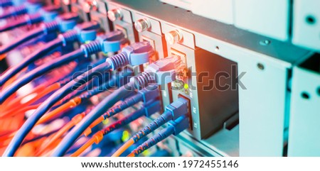 Fiber Optical cables connected to an optic ports and Network cables connected to ethernet ports