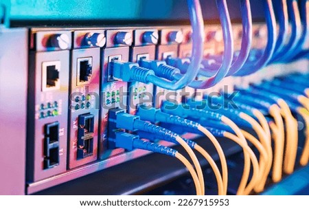 Fiber Optical cables connected to an optic ports and Network cables connected to ethernet ports