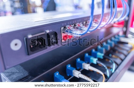 Fiber Optical cables connected to an optic ports and Network cables connected to ethernet ports