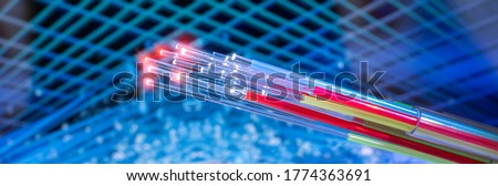 Fiber optics network cable on technology background