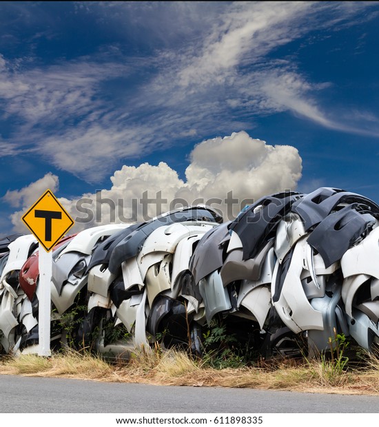 Fiber plastic bumper cars are\
stacked on a paved mountain with signposts, where the sky is the\
sky.