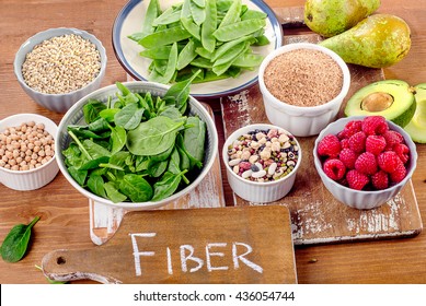 Fiber rich foods on a wooden board. Healthy eating. Top view - Shutterstock ID 436054744