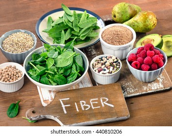 Fiber rich foods on wooden board. Healthy eating. Top view - Shutterstock ID 440810206