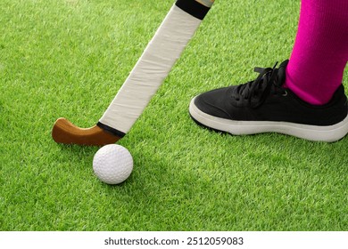 Field with ball and stick for hockey, fitness and training in the stadium. Close-up, ground and equipment for a competition, game or tournament in a stadium or grass in bokeh. - Powered by Shutterstock