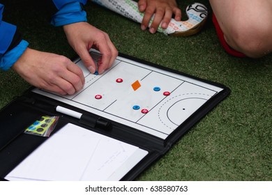 Field hockey coach hands showing some play on magnetic board - Powered by Shutterstock