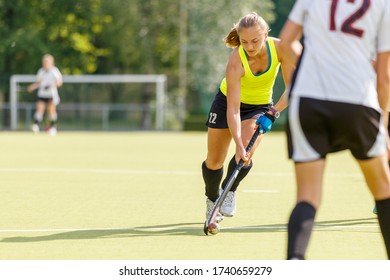 Field hockey female player lead the ball in attack in the game