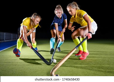 Field hockey female players struggle for the ball. Concept image hockey team game