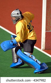 A Field Hockey Goalie Readies To Protect The Goal.