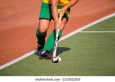 Field Hockey Player, In Possesion Of The Ball, Running Over An Astroturf Pitch, Looking For A Team Mate To Pass To