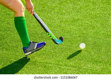 Field Hockey Player, In Possesion Of The Ball, Running Over An Astroturf Pitch, Looking For A Team Mate To Pass To