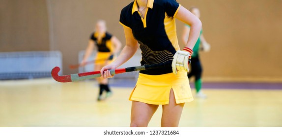 Field Hockey Player, In Possesion Of The Ball, Running Over An Astroturf Pitch, Looking For A Team Mate To Pass To