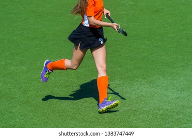 Field Hockey Player, In Possesion Of The Ball, Running Over An Astroturf Pitch, Looking For A Team Mate To Pass To