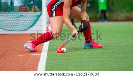 Field Hockey player, ready to pass the ball to a team mate