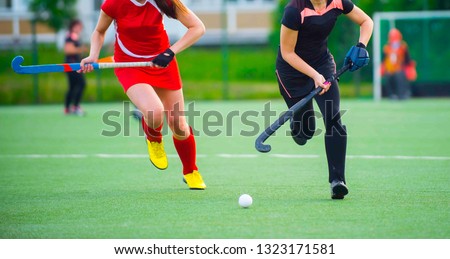 Field Hockey player, ready to pass the ball to a team mate