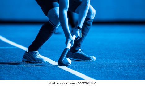 Field Hockey player,ready to pass the ball to a team mate
Blue filter. - Powered by Shutterstock