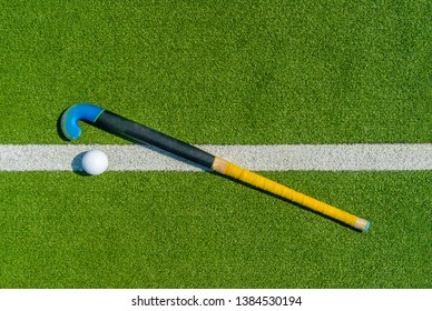 Field Hockey Stick And Ball On Green Grass