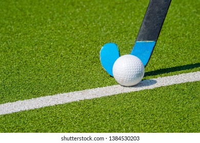 Field Hockey Stick And Ball On Green Grass