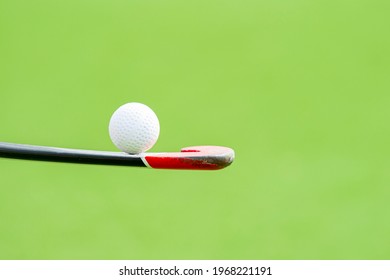 Field hockey stick and ball on green background. Professional sport concept - Powered by Shutterstock