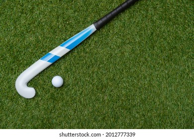 Field hockey stick and ball on the green field. Professional sport concept - Powered by Shutterstock