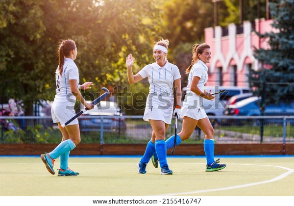 Field hockey team players cheer each other with\
success attack and goal\
score.
