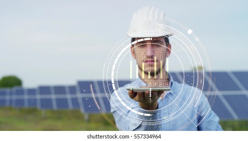 In a field photovoltaic solar panels an engineer, thanks to holography and augmented reality, check their operation with the sun and their productivity. Concept:renewable energy,technology,electricity