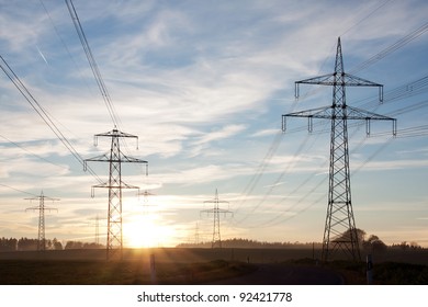 Field with power transport lines in the dusk - Powered by Shutterstock