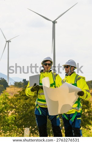 Field project managers synchronizing operational schedules via smartwatch at industrial construction site. Civil engineers executing logistics planning for energy infrastructure.