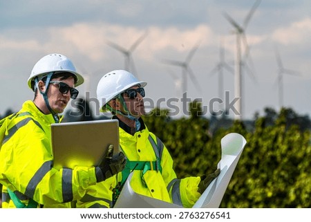 Field project managers synchronizing operational schedules via smartwatch at industrial construction site. Civil engineers executing logistics planning for energy infrastructure.