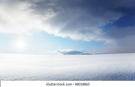 Field Of Snow And Cloudy Sky