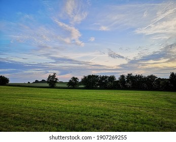 Field With Treeline And Blue, Cloudy Sky