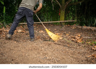 Field Work: Man Using Rake to Clear Land – Essential Farming Task - Powered by Shutterstock