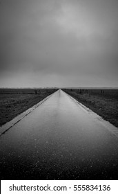 fields, earth and sky divided by the man made road