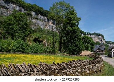 Fields with yellow flowers in the village of Baume les Messieurs in the Jura in France - Shutterstock ID 2199259285