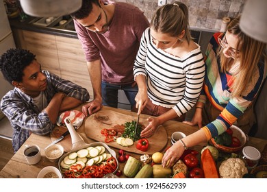 Fiends Preparing Vegetarian Meal.They Preparing Food And Making Fun In The Kitchen.Home Party.