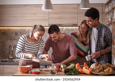 Fiends preparing vegetarian meal.They preparing food and making fun in the kitchen.Home party. - Powered by Shutterstock