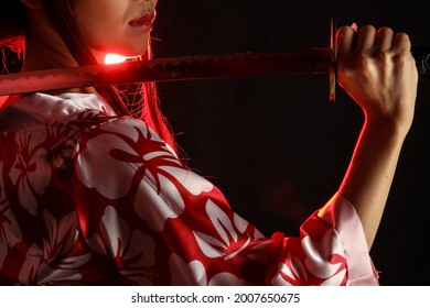 Fierce Woman Holding A Katana In Red Light