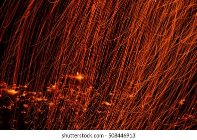 Fiery Embers Falling In Darkness Background