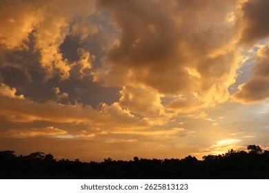 Fiery red and orange sunset casting a dramatic glow across the sky, with warm hues illuminating the horizon and silhouetting the surrounding landscape, capturing the tranquil beauty of dusk.