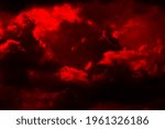   Fiery red sky. Thunderclouds. Dramatic sky with heavy clouds. Fantastic, magical, fantasy scene. Bright toned background for design.                             