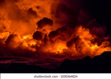 Fiery shots of the active lava flow and volcanos on the Big Island of Hawaii watching the lava flow into the ocean during sunset 