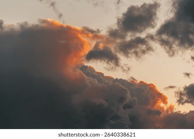 Fiery storm clouds at sunset with dramatic light and textured sky