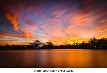 A fiery sunrise over the Tidal Basin in Washington DC featuring the Jefferson Memorial.