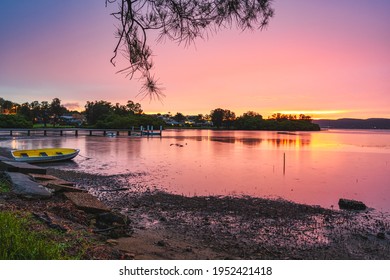 A fiery sunset at Green Point NSW Australia. the clouds lit up red in the sky - Shutterstock ID 1952421418