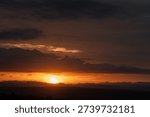 Fiery sunset with layered clouds over the Masai Mara, Kenya.